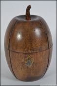 An unusual carved fruitwood tea caddy in the form of a melon having hinged top complete with the