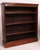A late Edwardian / Victorian mahogany open window bookcase having adjustable shelves being raised