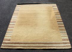 A large late 20th century good quality contemporary floor rug of deep pile construction in beige /