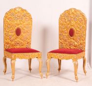 A pair of unusual gilt metal Indian wedding throne chairs having gilded metal overlays to the back