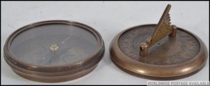 A brass cased compass and sundial,