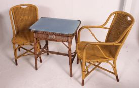 A par of early 20th century whicker conservatory / garden arm chairs along with a matching table,