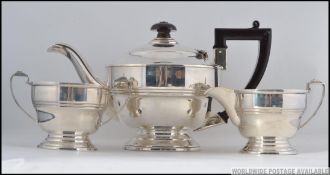 A silver hallmarked teapot with matching sugar bowl and creamer.