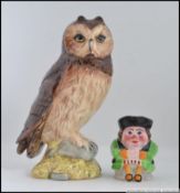 A Royal Doulton Owl figurine by John E Tongue together with a miniature toby jug.