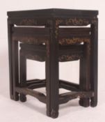A Chinese black laquered soapstone inlaid nest of tables.