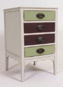 An early 20th century painted two town upcycled pedestal chest of drawers being raised on square