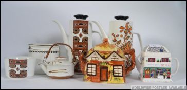 A collection of ceramic Teapots and coffee pots to include retro Meakin,