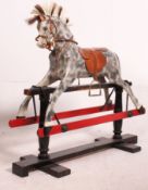 An early 20th century wooden rocking horse on glider in the manner of Lines Bros.