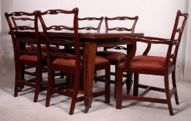A Good Edwardian mahogany inlaid wind out extending dining table complete with additional leaf and