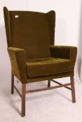 An early 20th century wing back armchair,