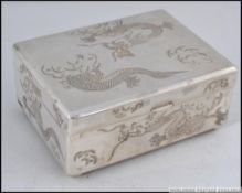 A highly decorated Chinese Sterling Silver cigarette case, chase decorated with dragons,