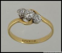 An 18ct gold and Platinum diamond trilogy ring set with three good diamonds a total of approx 50pts.