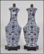 A pair of 20th century Japanese blue and white vases having a rich blue background with a foliate