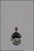 A silver and marcasite on onyx Cartier style pendant necklace