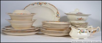 An Alfred Meakin dinner service together with an Ivory England part dinner service to include