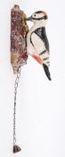An unusual cast iron door knocker in the form of a wood pecker.
