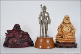 A pair of non matching 20th century resin Buddha along with a novelty table lighter in the form of