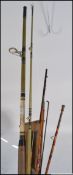 A collection of vintage fishing rods and fishing reels to include both fly and sea fishing rods and