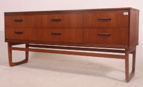 A vintage teak Danish style 6 drawer sideboard dresser raised on shaped arch supports,