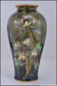 A 20th century Moorcroft type green ground tubeline glazed vase by Vienna, pattern marked Turn,