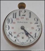 A vintage 8 Jours Fish Eye clock having thick glass with brass surround and loop. Measures: 7cm H.