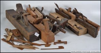 A mixed collection of wood working planes .