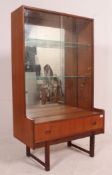 A vintage mid century teak mirror back display bookcase stand having breakfront centre base drawer