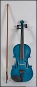 A contemporary violin by Windsor in metallic blue with bow and complete with the case