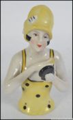 A 20th century ceramic art deco style pin dolly figure of an art deco lady