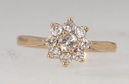 A 9ct gold daisy ring with diamond encrusted flower head approx 30pnts. Total weight 1.