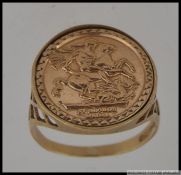 A hallmarked 9ct gold St Georges Medal signet ring with pierced lattice shoulders. Size Q.5.