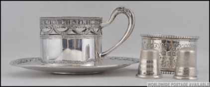 A German silver 800 marked coffee can holder of pierced form together with saucer by Hugo Bohm