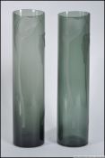 A Modern pair of tall cylindrical smoked grey glass flower vases heavily etched with Calla lillies