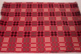 A stunning 20th century Welsh blanket in red with white, grey and black medallion design.