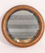A 20th century up-cycled gilt framed wall mirror having an unusual mount to the mirror.