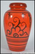 A 1970's retro orange ceramic Tokio Gouda Flora dutch vase bearing stamps to the base.