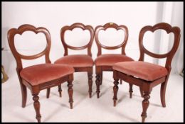 A set of 5 Victorian mahogany balloon back dining chairs being raised on turned legs with drop in