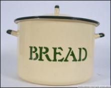 A vintage green enamel lidded circular bread bin, having notation to the front in black for Bread.