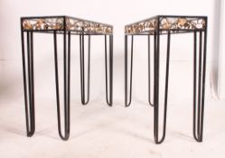 A pair of vintage cast iron and glass console tables.
