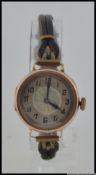 A hallmarked 9ct gold wrist watch with leather strap. Import mark for London 1922. Maker GS.