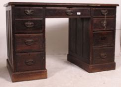 An Edwardian mahogany oak twin pedestal kneehole desk with drawers to each pedestal and central