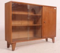 A vintage ' utility / cc41 ' type display / bookcase stand with glass sliding doors to the left