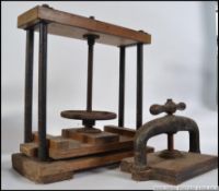 An early 20th century large wooden and cast iron book press with screw thread together with