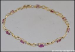 A 14CT yellow gold bracelet , set with 10 rubies 4.