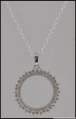 A silver and CZ halo style pendant necklace on silver chain .