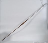 A 20th century African spear, the front end has a blade formed on a metal shaft,