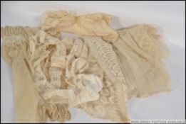 A stunning Edwardian lace wedding dress being cut down to create an unfinished christening gown.