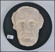 A 20th century study plastercast Death Mask of an elderly gent mounted on to board.