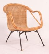 A vintage 1960's rattan weave bedroom chair having shaped rattan weave seat over tubular metal