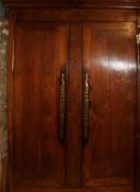 A 19th century French large fruitwood armoire raised on bracket feet with twin full length panel